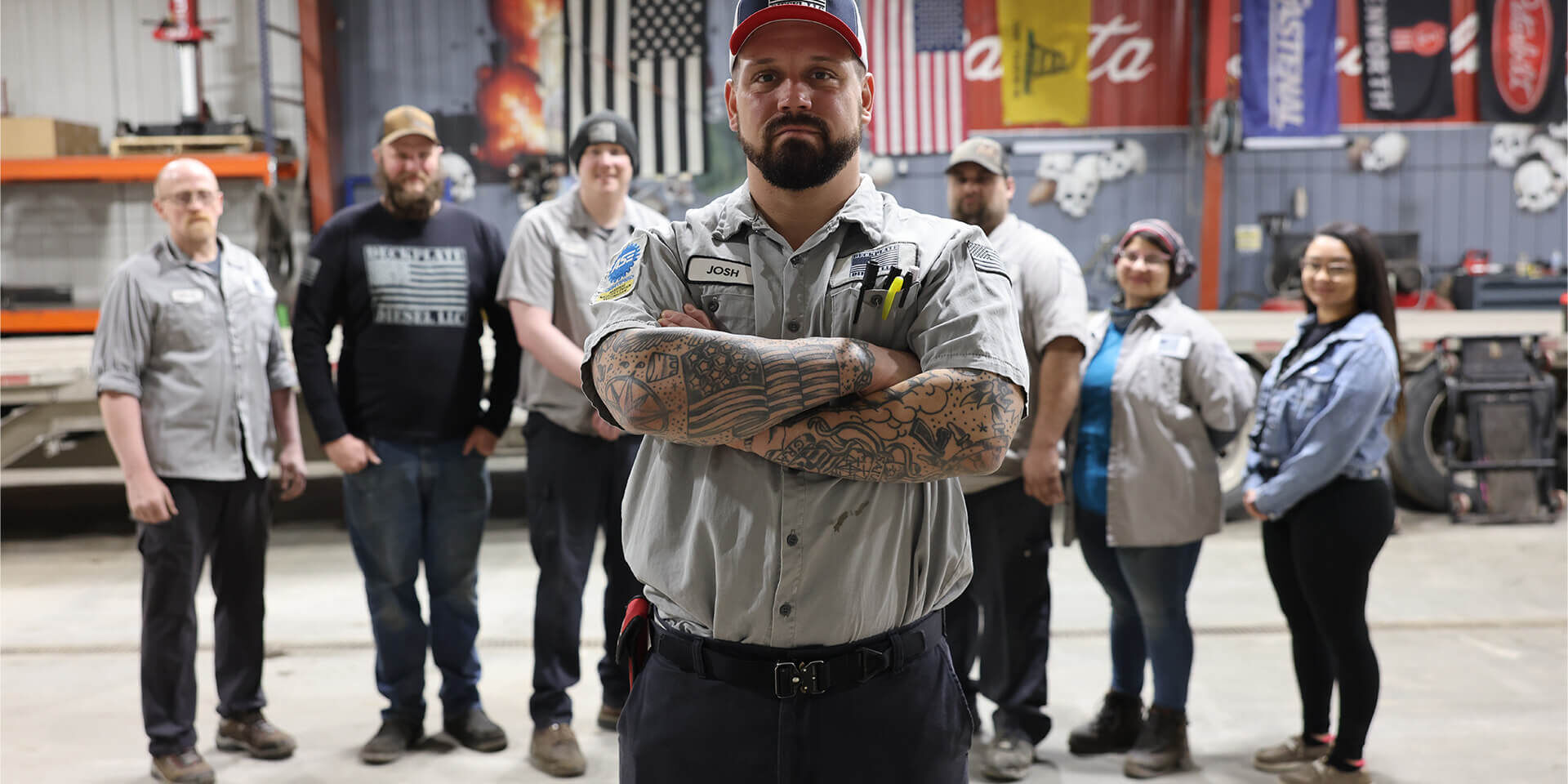 Josh Seley, Owner of Deckplate Diesel, stands in front of Deckplate Diesel team inside the Deckplate Diesel building in Fargo, ND.